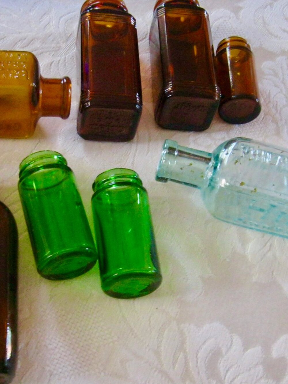 VINTAGE APOTHECARY BOTTLES, MANY WITH TEXT REGARDING WHAT WAS IN THEM